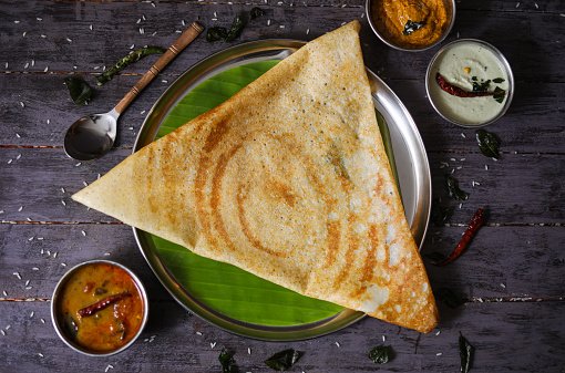 Crispy South Indian dosa served with chutneys and sambar